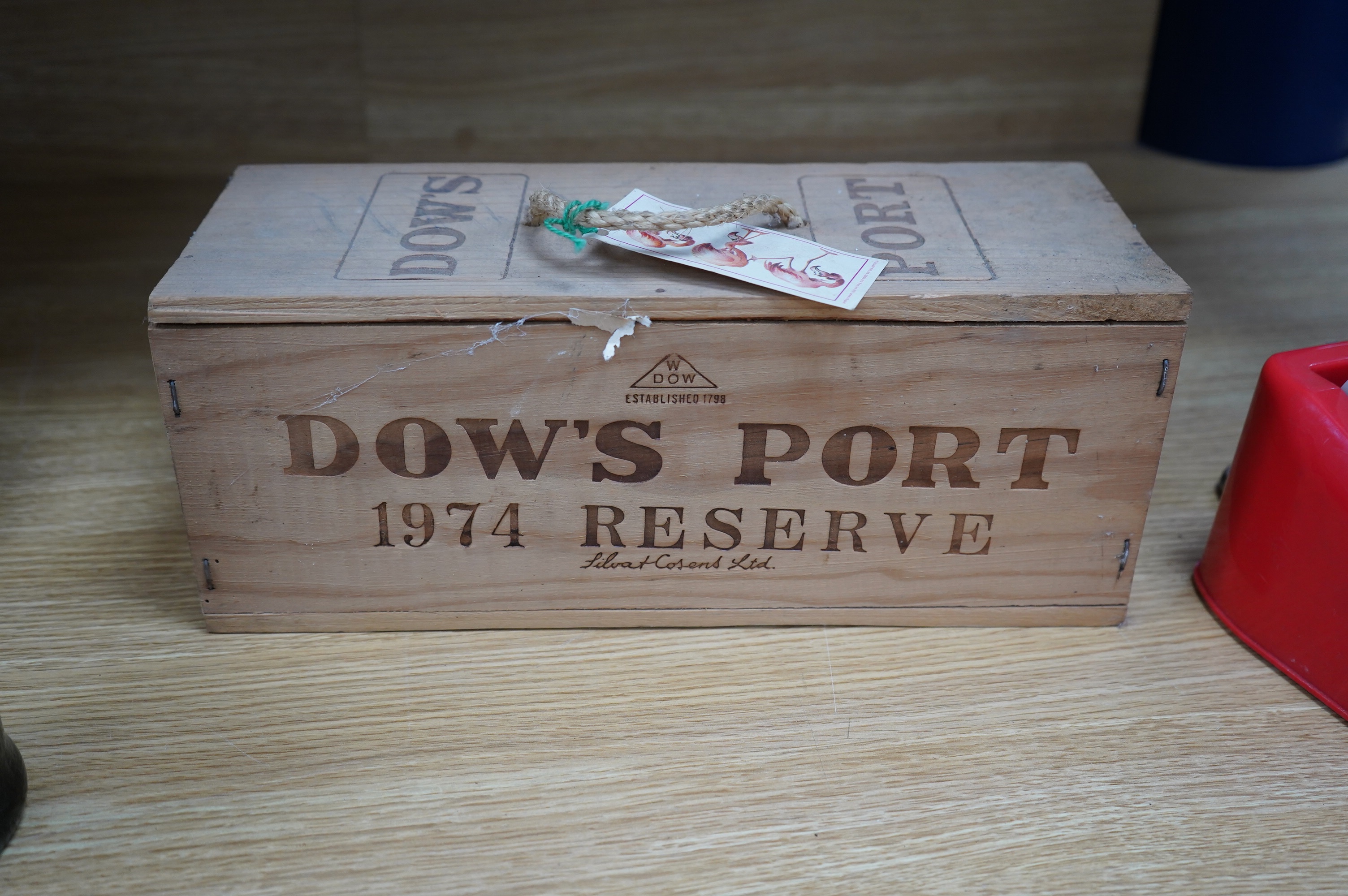 One wooden box of unopened Dow’s Port Reserve 1974, together with a bottle of Sandeman Tawny Port. Condition - storage unknown
